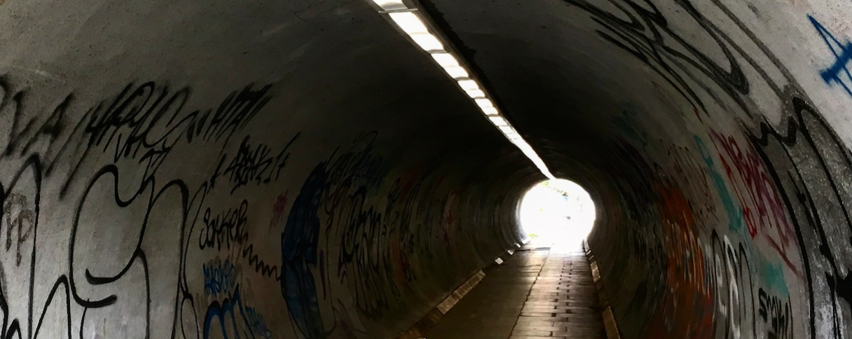 A foot tunnel with grafitti